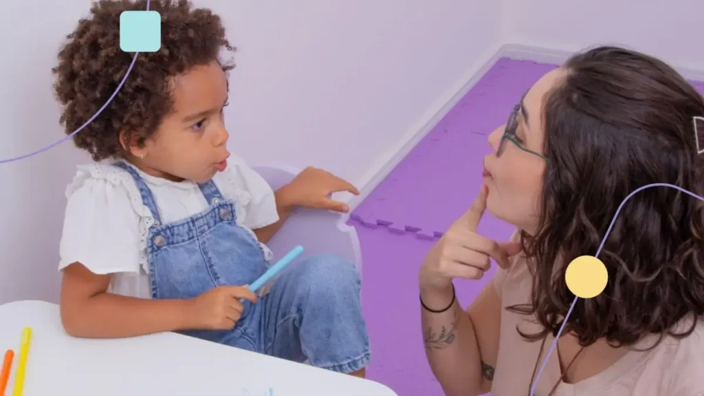 Profissional de fonoaudiologia no autismo atendendo menina em sala sensorial.