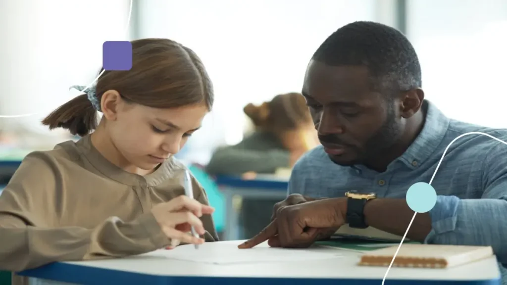 Professor praticando educação inclusiva com aluna autista.