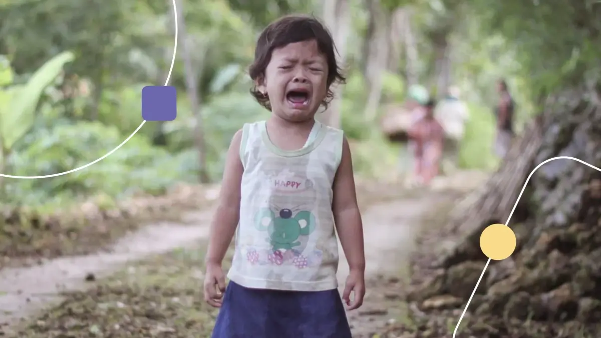 Criança com crises no autismo em um local arborizado.