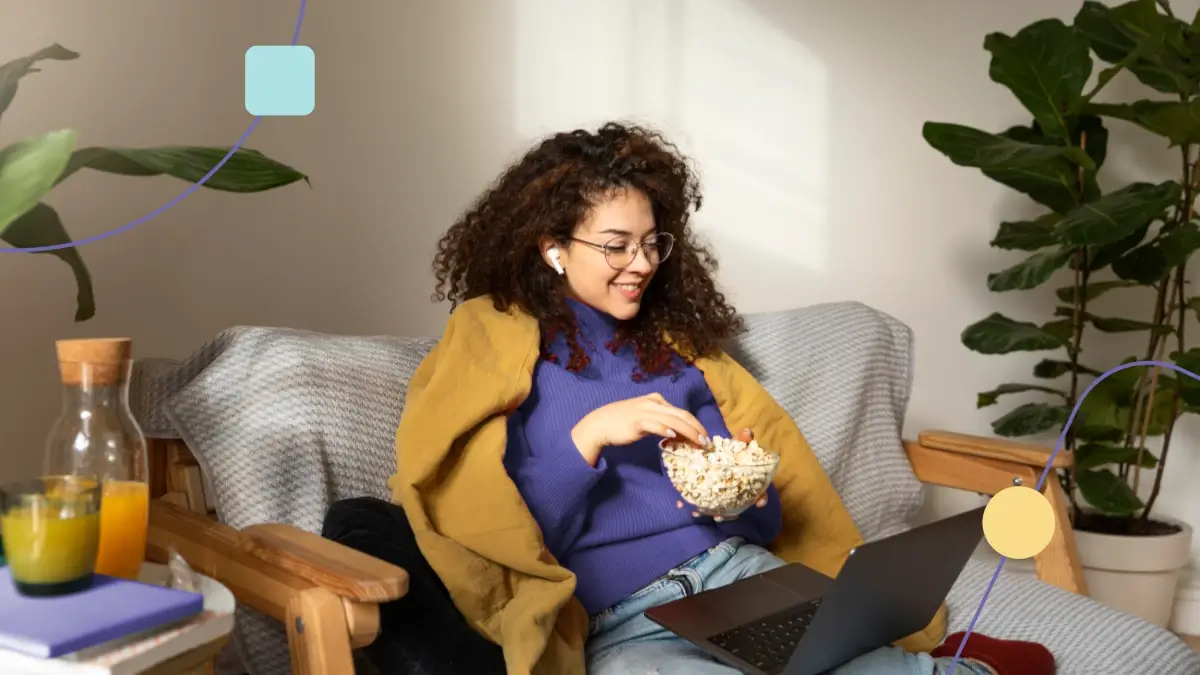 Menina assistindo 6 filmes e séries scom personagens autistas em seu laptop