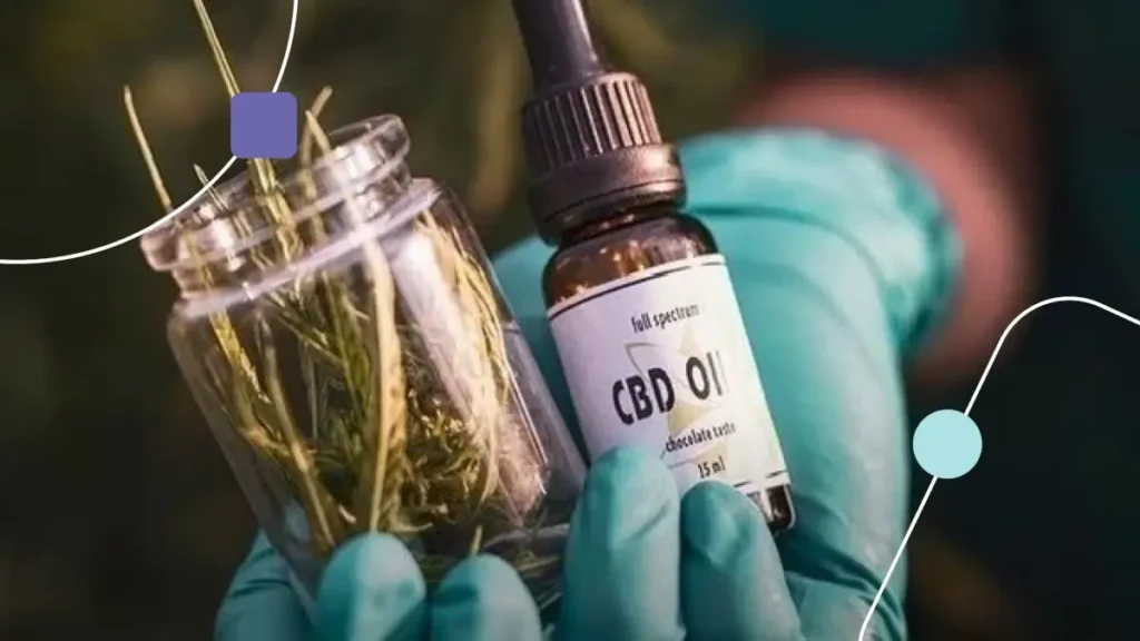 canabidiol: mãos com luvas segurando um conta-gotas na direita e um frasco de CBD na esquerda