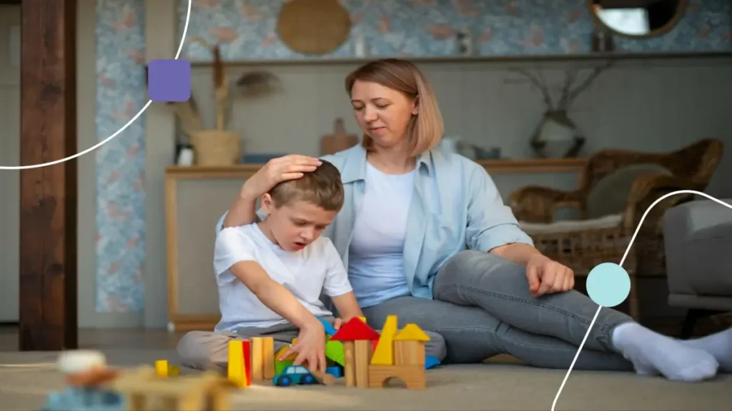 Mãe praticando regulação emocional com filho autista que está triste devido a ter pedido na brincadeira.